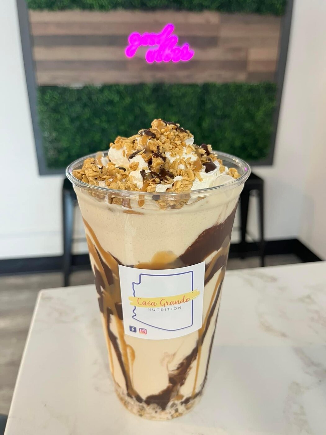 Caramel protein shake topped with whipped cream and granola at Casa Grande Nutrition