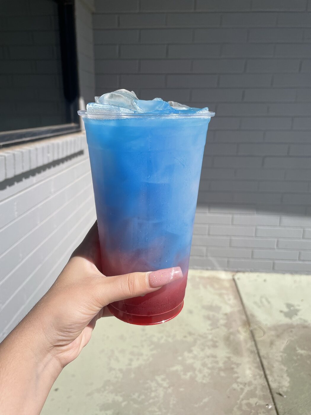 Blue and red layered energy tea in a 32oz cup in Casa Grande AZ
